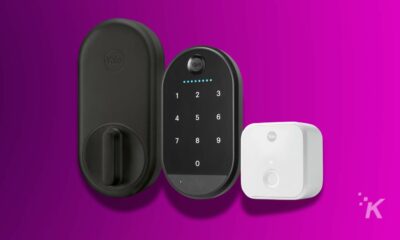 Yale smart lock system components on a purple background, including a door handle, keypad unit, and a wireless hub.