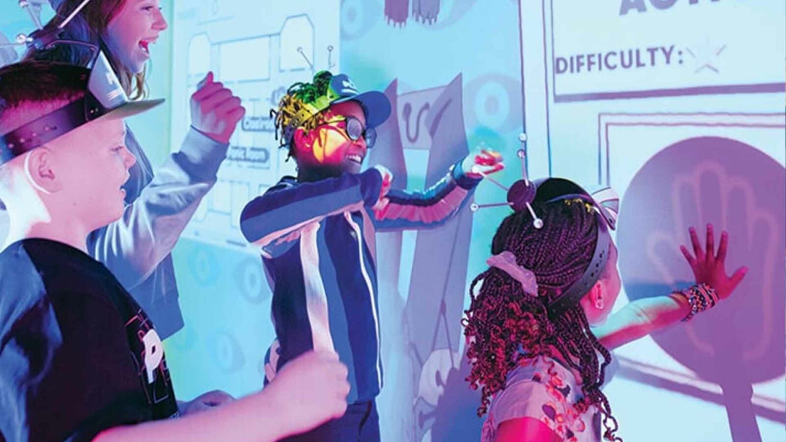 Kids playing with interactive digital wall game.