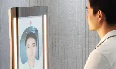 man looking at a smart mirror that is checking his health