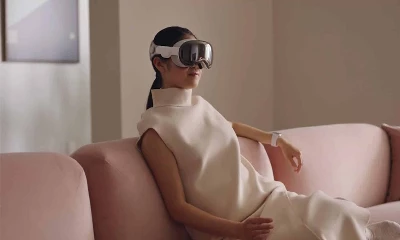 A person wearing a Apple Vision Pro in a living room setting.