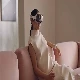 A person wearing a Apple Vision Pro in a living room setting.
