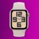 render of an apple watch se 2nd gen in starlight on a purple background