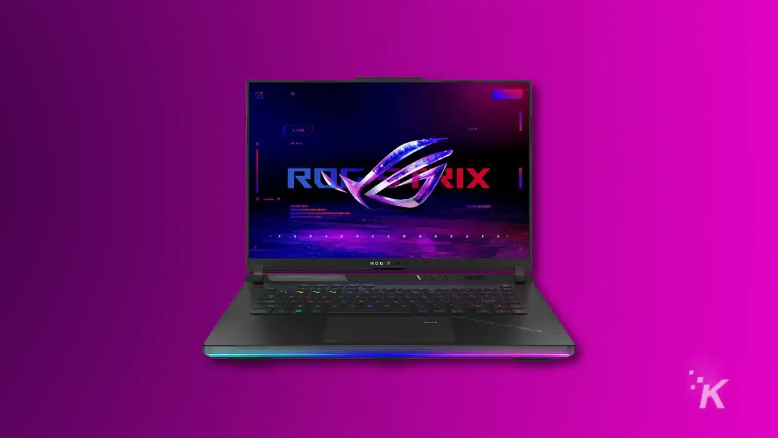 ROG Strix laptop with glowing logo on screen.