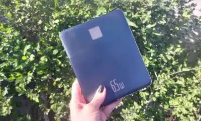 Baseus Blade 2 held in front of green hedge