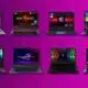 Eight gaming laptops on a purple background.