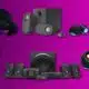 Assorted home audio speaker systems on purple background.