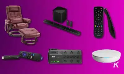 Home theater gadgets and massage recliner on purple background.