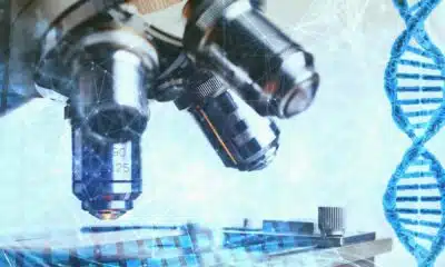 Microscope examining DNA strands, scientific research concept.