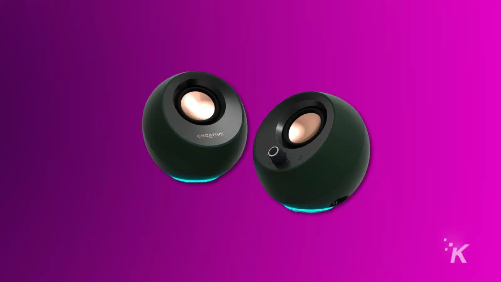 render of creative pebble pro computer speakers on a purple background