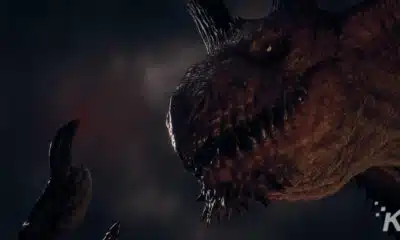 A close-up image of a menacing dragon's head with detailed scales, sharp teeth, and horns against a dark, cloudy background.