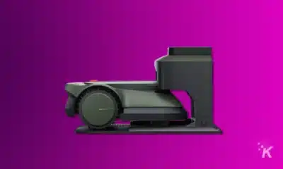 render of ecovacs robotic mower and docking station on a purple background