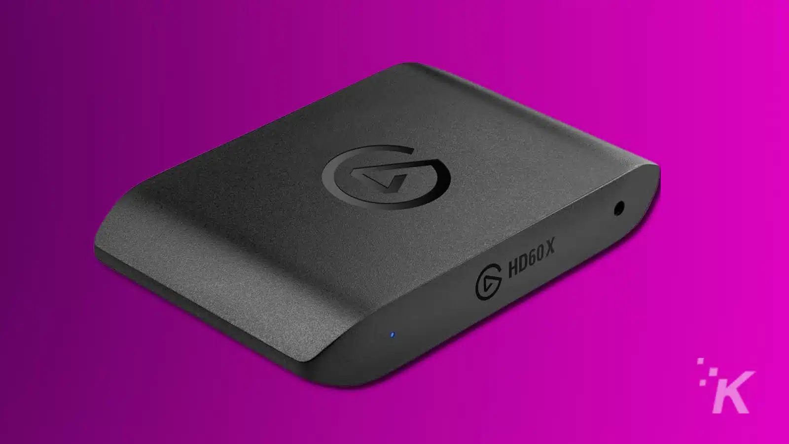 Black external capture card on purple background.