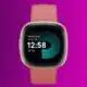 A smartwatch with a peach strap displays the time 12:58 and a readiness score of 90 on its screen against a purple background.