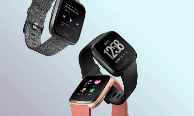 three fitbit versa blue background