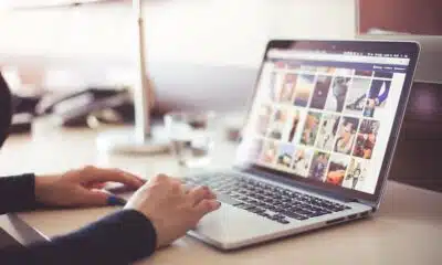 person uploading photos on laptop