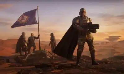 Futuristic soldiers with flag on Mars-like terrain.