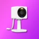This is a stylized graphic of a white web camera with a prominent lens, mounted on a stand, against a vibrant purple background.