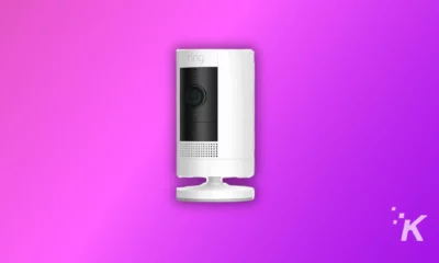 A image shows ring camera in white color on the purple background