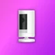 A image shows ring camera in white color on the purple background
