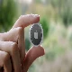 apple airtags tracker held in fingers