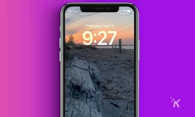 iPhone lock screen with picture of a sunset at the beach.
