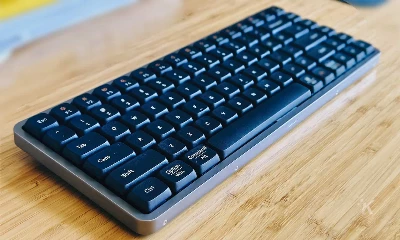 A lowfree flow mechanical keyboard sits on the table.