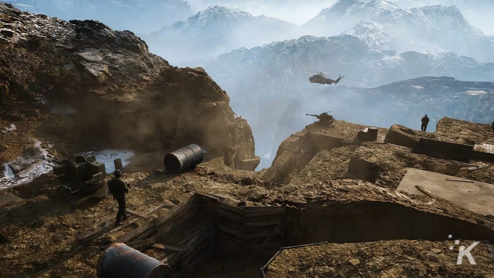 Military outpost on mountain with helicopter and soldiers.