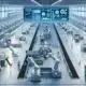 Modern automated factory floor with robotics and digital displays.