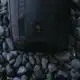 nomatic camera backpack on pebbles