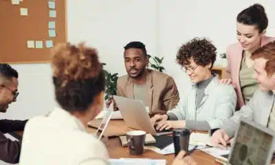People in meeting for a PR firm with laptop.