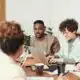People in meeting for a PR firm with laptop.