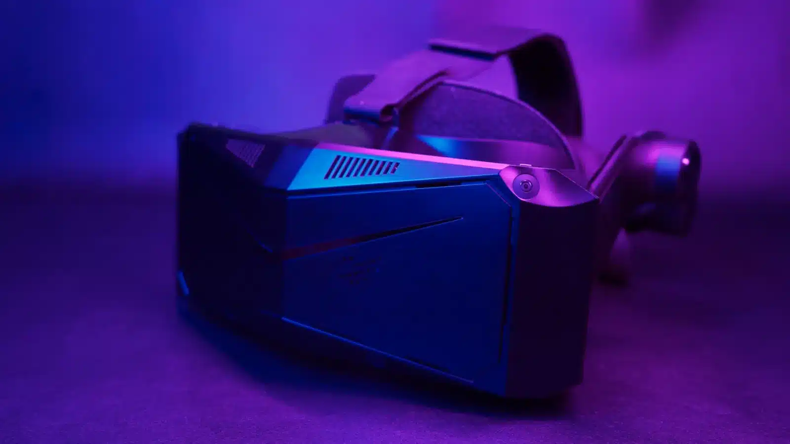 pimax crystal light vr headset under purple ambient lighting.