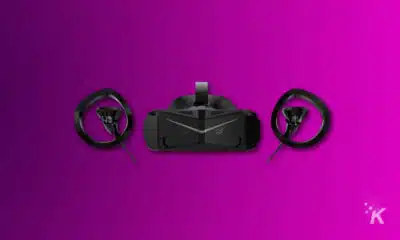 render of a VR headset and controllers on purple background.