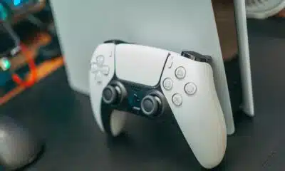 dualsense controller in front of a playstation 5 console