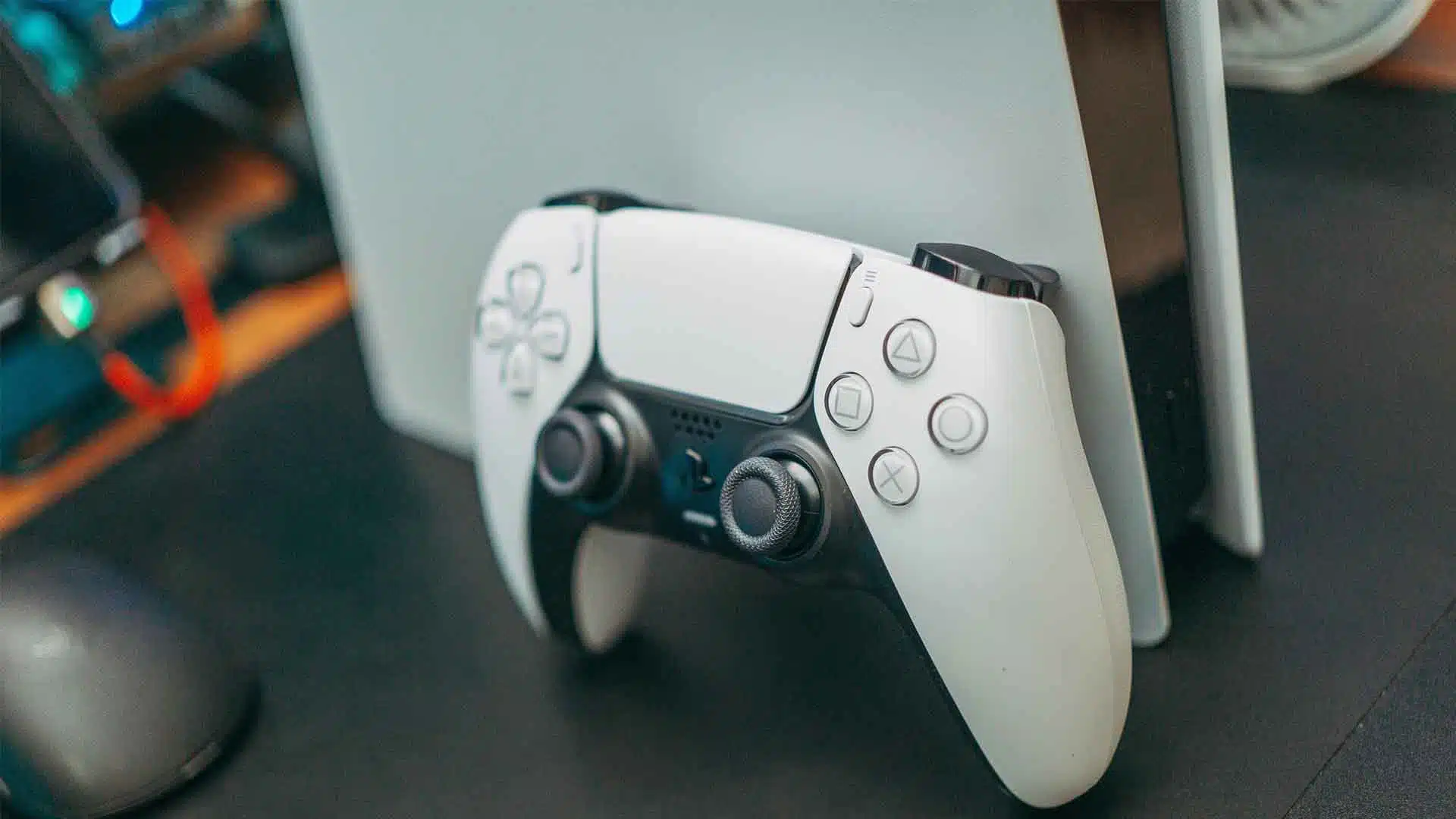 dualsense controller in front of a playstation 5 console