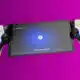 Gaming tablet with console controllers on purple background.