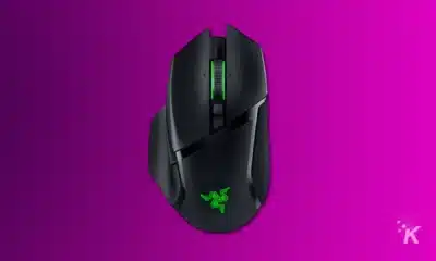a render of a razer basilisk v3 pro gaming mouse on a purple background