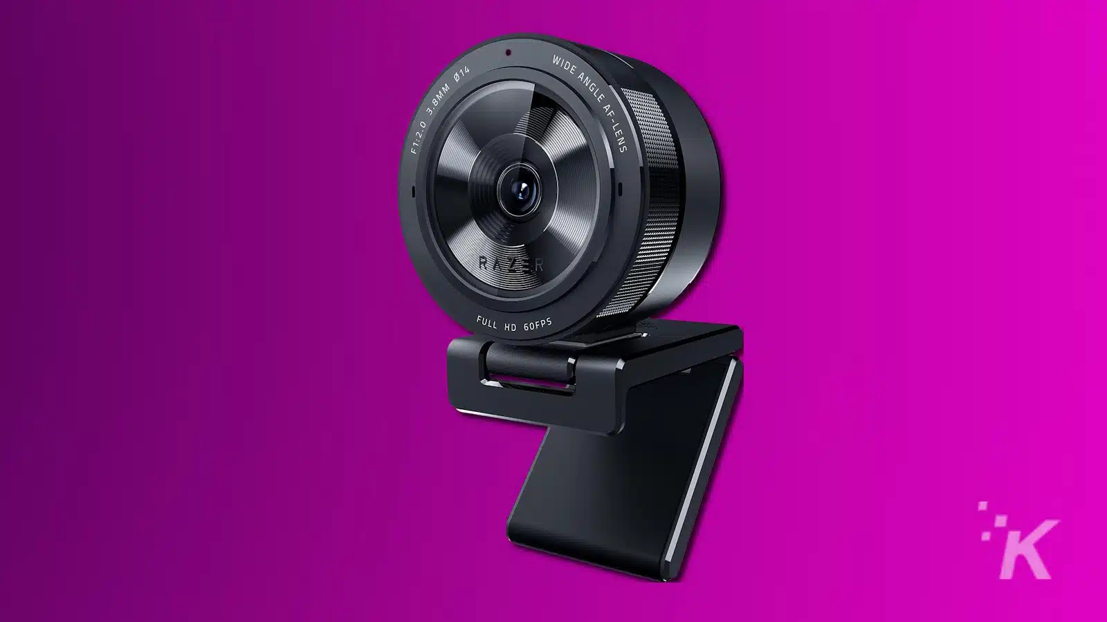 Modern web camera on purple background.