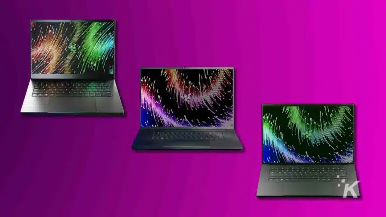 Three laptops with colorful screen savers on purple background.