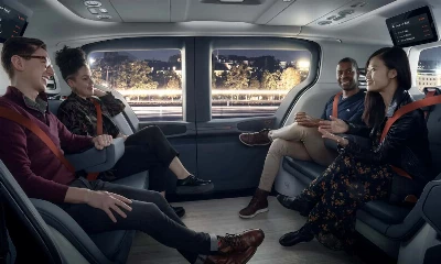 A group of people ride the train together.