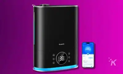 Smart humidifier with mobile app control on purple background.