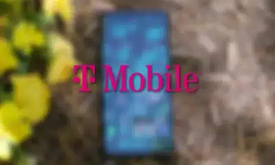 t-mobile logo floating over a blurred smartphone on the ground