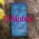 t-mobile logo floating over a blurred smartphone on the ground