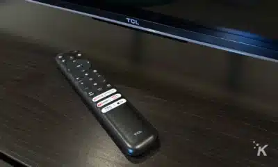 A TCL remote control sits on a table.