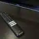 A TCL remote control sits on a table.