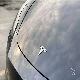 tesla badge on model 3 with full self-driving