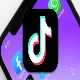 tiktok logo with blurred smartphone in the background