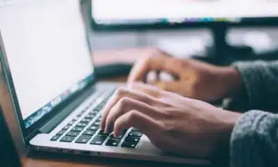 person typing on a laptop