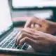 person typing on a laptop
