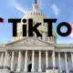 Logo of TikTok superimposed on the United States Capitol Building under a clear blue sky.